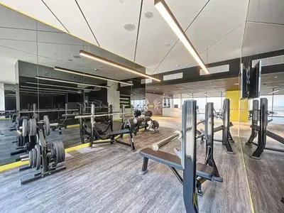 a gym with several treadmills and weights at Vogue Business Bay Aykon City Tower Close to Downtown Burj Khalifa and Dubai Mall, Two Bedroom Apartment with Large Balcony Sea view, Access to all Amenities in Dubai