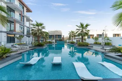 an image of a swimming pool at a hotel at Modern 1BR with Terrace, Rooftop Pool and PS5 in JVC in Dubai
