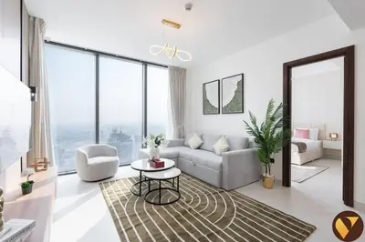 a living room with a couch and a table at Vogue Al Maktoum City Sobha Hartland The Crest Near to Downtown, Burj Khalifa and Dubai Mall, Three Bedroom plus Kid's room apartment with Balcony and City View, Access to all Amenities in Dubai