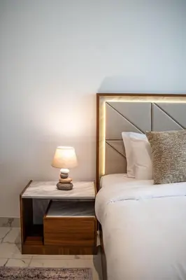 a bedroom with a bed and a table with a lamp at Airstay - Modern 1BR - Pool Views - Azizi 61 - Monthly Offer Available in Dubai