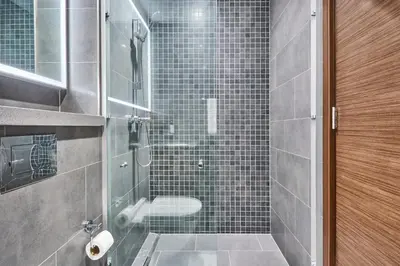 a bathroom with a glass shower with a toilet at STAY BY LATINEM Luxury 2BR Holiday Home CB 1313 Near Burj Khalifa in Dubai