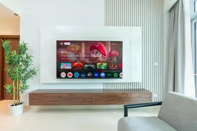 a flat screen tv in a living room at PVH - 1BR with Burj Khalifa View - Imperial Avenue in Dubai