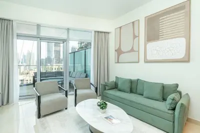 a living room with a couch and a table at PVH - 1BR with Burj Khalifa View - Imperial Avenue in Dubai