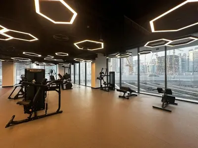 a gym with treadmills and machines in a building at FIRST CLASS 1BR Modern Serenity , Near Downtown in Dubai
