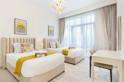 a hotel room with two beds and a desk at Luxe 6BR Semi-Detached Villa Steps from the Lagoon in Dubai