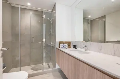 a bathroom with a shower and a sink at Luxe 6BR Semi-Detached Villa Steps from the Lagoon in Dubai