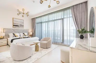 a white bedroom with a bed and a large window at Luxe 6BR Semi-Detached Villa Steps from the Lagoon in Dubai