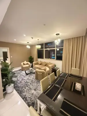 a living room with a table and a dining room at Wecation- Chic 2BR Damac Maison Cour Jardin Business Bay in Dubai