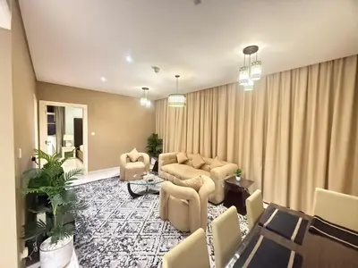 a living room with a couch and chairs and a table at Wecation- Chic 2BR Damac Maison Cour Jardin Business Bay in Dubai