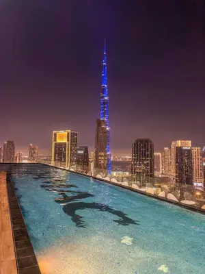 a swimming pool with a city skyline at night at Luxury 2B Burj Khalifa NYE Views, 5-Star Amenities in Dubai