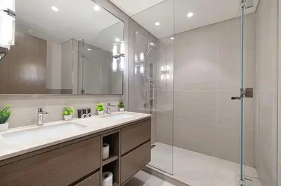 a bathroom with a sink and a glass shower at Full Burj Khalifa And Fountains View Exclusive 2BR Luxury Apartment In The Heart Of Downtown Dubai in Dubai