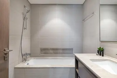 a bathroom with a tub and two sinks at Full Burj Khalifa And Fountains View Exclusive 2BR Luxury Apartment In The Heart Of Downtown Dubai in Dubai