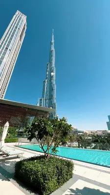 a view of the burj khalifa from the pool in the city at Full Burj Khalifa And Fountains View Exclusive 2BR Luxury Apartment In The Heart Of Downtown Dubai in Dubai