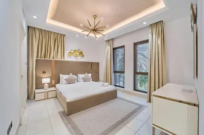 a bedroom with a bed and a ceiling fan at FAM Living - 2 Bedroom Old Town Dubai Stay in Dubai