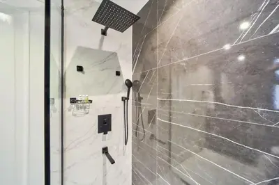a bathroom with a shower with a glass door at FAM Living - 2 Bedroom Old Town Dubai Stay in Dubai