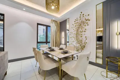 a dining room with a glass table and white chairs at FAM Living - 2 Bedroom Old Town Dubai Stay in Dubai