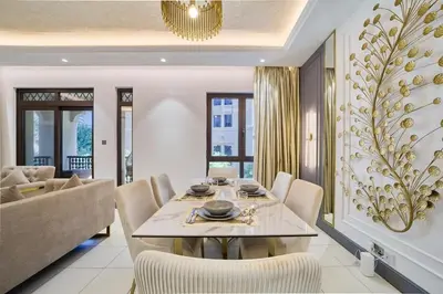 a dining room with a table and chairs at FAM Living - 2 Bedroom Old Town Dubai Stay in Dubai