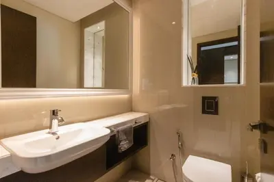 a bathroom with a sink and a toilet and a mirror at Unobstructed Burj Fountain View Near Dubai Mall in Dubai