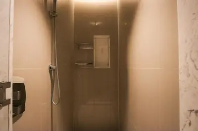 a shower with a glass door in a bathroom at Unobstructed Burj Fountain View Near Dubai Mall in Dubai