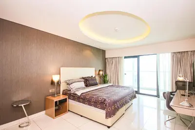 a bedroom with a large bed and a large window at Luxury Fully Furnished 1BHK With Burj Khalifa View at paramount Towers in Dubai