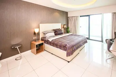 a bedroom with a large bed and a large window at Luxury Fully Furnished 1BHK With Burj Khalifa View at paramount Towers in Dubai
