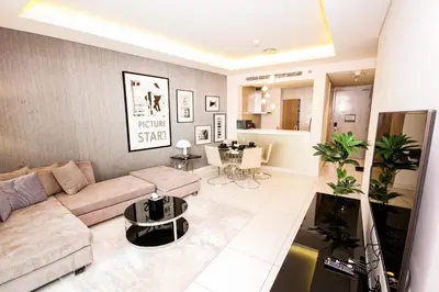 a living room with a couch and a table at Luxury Fully Furnished 1BHK With Burj Khalifa View at paramount Towers in Dubai