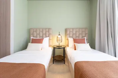 two beds sitting next to each other in a room at Meydan - Modern Family - 2BR Apartment - Azizi Riviera in Dubai