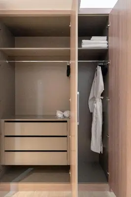 a walk in closet with a dresser and towels at Meydan - Modern Family - 2BR Apartment - Azizi Riviera in Dubai