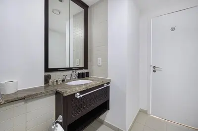 a bathroom with a sink and a mirror at Restay Homes at The Residences Tower 1 - Full Burj Views from all apartments in Dubai