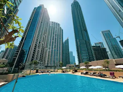 a swimming pool in a city with tall buildings at Restay Homes at The Residences Tower 1 - Full Burj Views from all apartments in Dubai