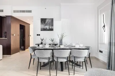 a dining room with a black table and chairs at Restay Homes at The Residences Tower 1 - Full Burj Views from all apartments in Dubai