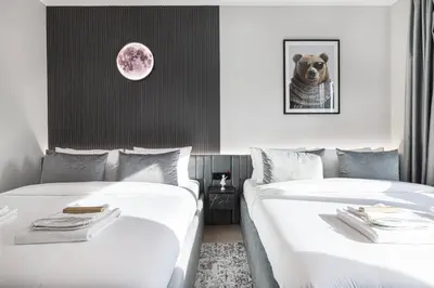 two beds in a hotel room with a dog on the wall at Restay Homes at The Residences Tower 1 - Full Burj Views from all apartments in Dubai