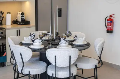 a dining room table with chairs and a tableasteryasteryasteryasteryasteryasteryastery at Upscale 4BR Villa, Bali Pool, Resort Escape in Dubai