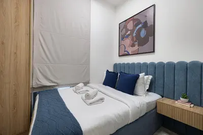 a bedroom with a bed with towels on it at Upscale 4BR Villa, Bali Pool, Resort Escape in Dubai