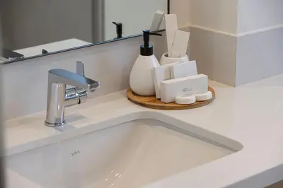 a sink in a bathroom with a mirror and a counter at Upscale 4BR Villa, Bali Pool, Resort Escape in Dubai