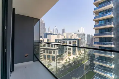 an apartment balcony with a view of a city at 1BR in Trillionaire Residences by Binghatti with canal view in Dubai