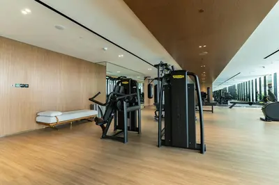 a gym with cardio equipment in a building at 1BR in Trillionaire Residences by Binghatti with canal view in Dubai