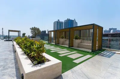 a pavilion on the roof of a building with plants at 1BR in Trillionaire Residences by Binghatti with canal view in Dubai