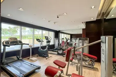 a gym with several treadmills and elliptical machines at High-Floor Studio Ghalia JVC with an Amazing View in Dubai