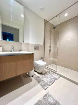 a bathroom with a toilet and a sink and a shower at Luxury 1BR with Huge Terrace with Creek Beach Lagoon in Dubai