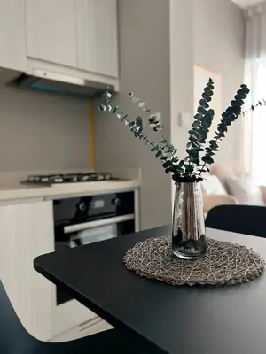 a vase filled with flowers sitting on a table at Stylish 1BR in Zada Tower near Business Bay Metro in Dubai