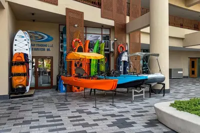 a building with a boat and a surfboard on display at Luxury Upgraded Palm Studio with Marina and Yacht Views in Dubai