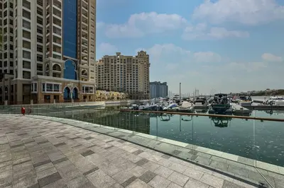 a marina with boats in the water next to buildings at Luxury Upgraded Palm Studio with Marina and Yacht Views in Dubai