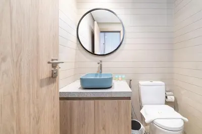 a bathroom with a blue sink and a mirror at Luxury Studio in Peninsula One, Bay Views in Dubai