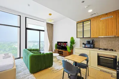 a living room with a green couch and a table at Chic Living in Meraki comfy studio in Dubai