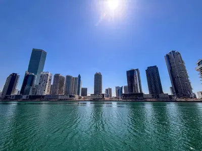 a view of a city from the water with buildings at Frank Porter - Peninsula Five, Business Bay in Dubai