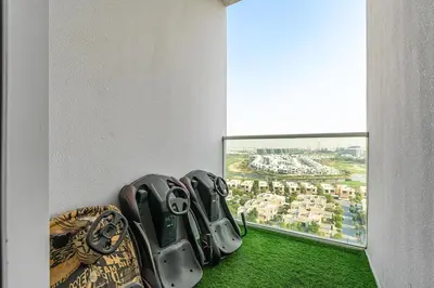 a group of gloves sitting on the floor next to a window at Modern 1Bed near Parks and Famous Golf Clubs in Dubai