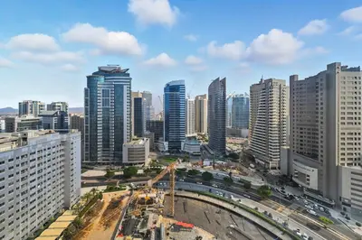 a city skyline with tall buildings and a highway at Spacious modern 2 Bed and Maids I Sleeps 7 in Dubai