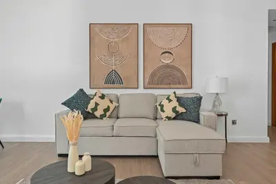 a living room with a couch and a table at Spacious modern 2 Bed and Maids I Sleeps 7 in Dubai