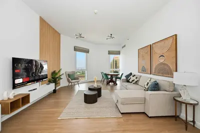 a living room with a couch and a tv at Spacious modern 2 Bed and Maids I Sleeps 7 in Dubai